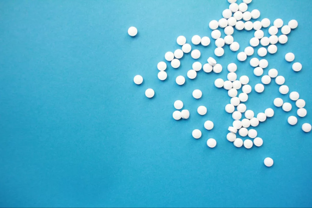 White tablets spread on a blue background