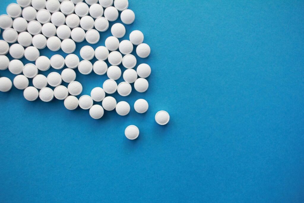 White tablets scattered on a blue background